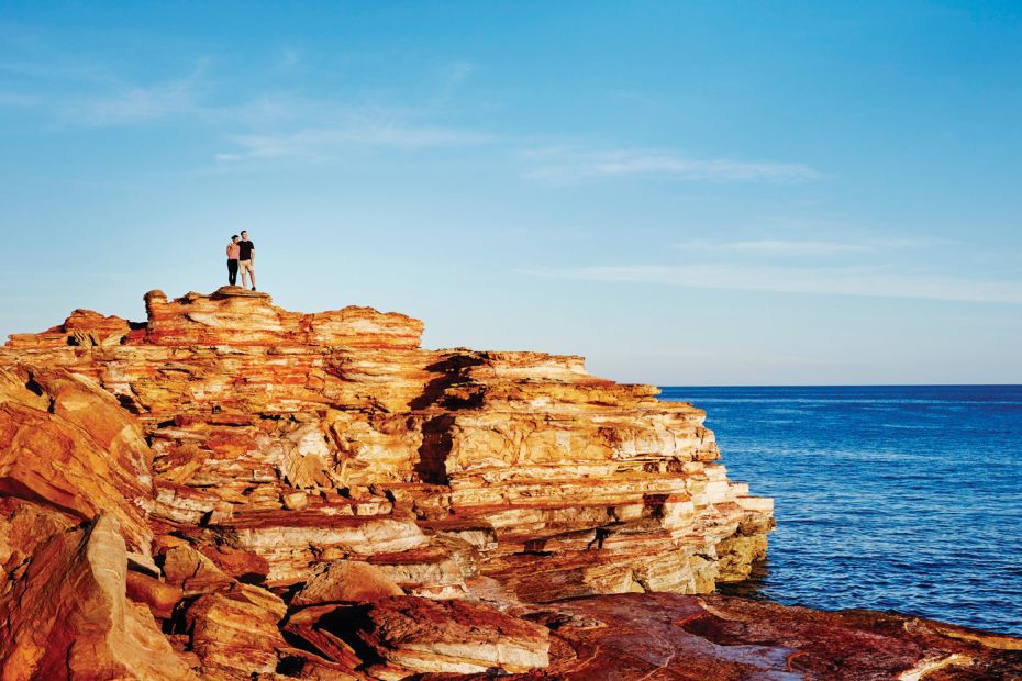 Couple standing on the rocks overlooking the coast at Gantheaume Point in Broome