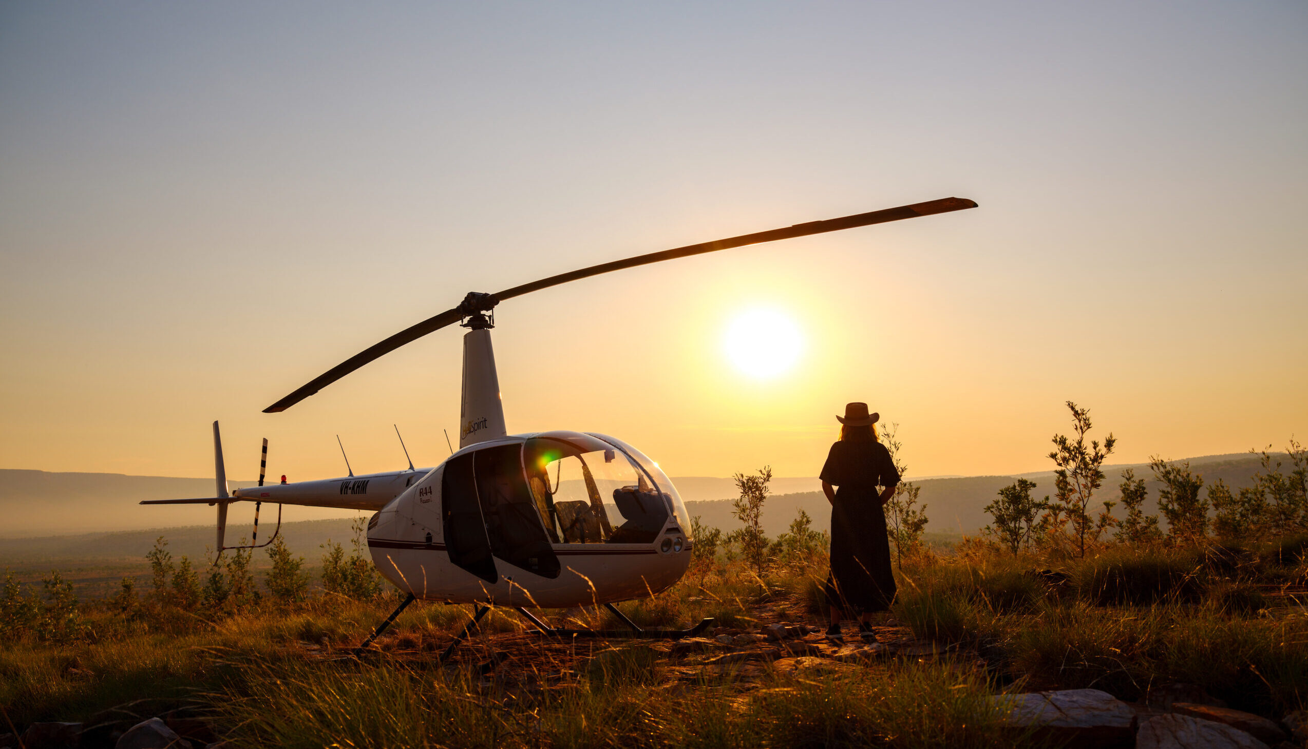 Helicopter with lady watching the sunset at El Questro