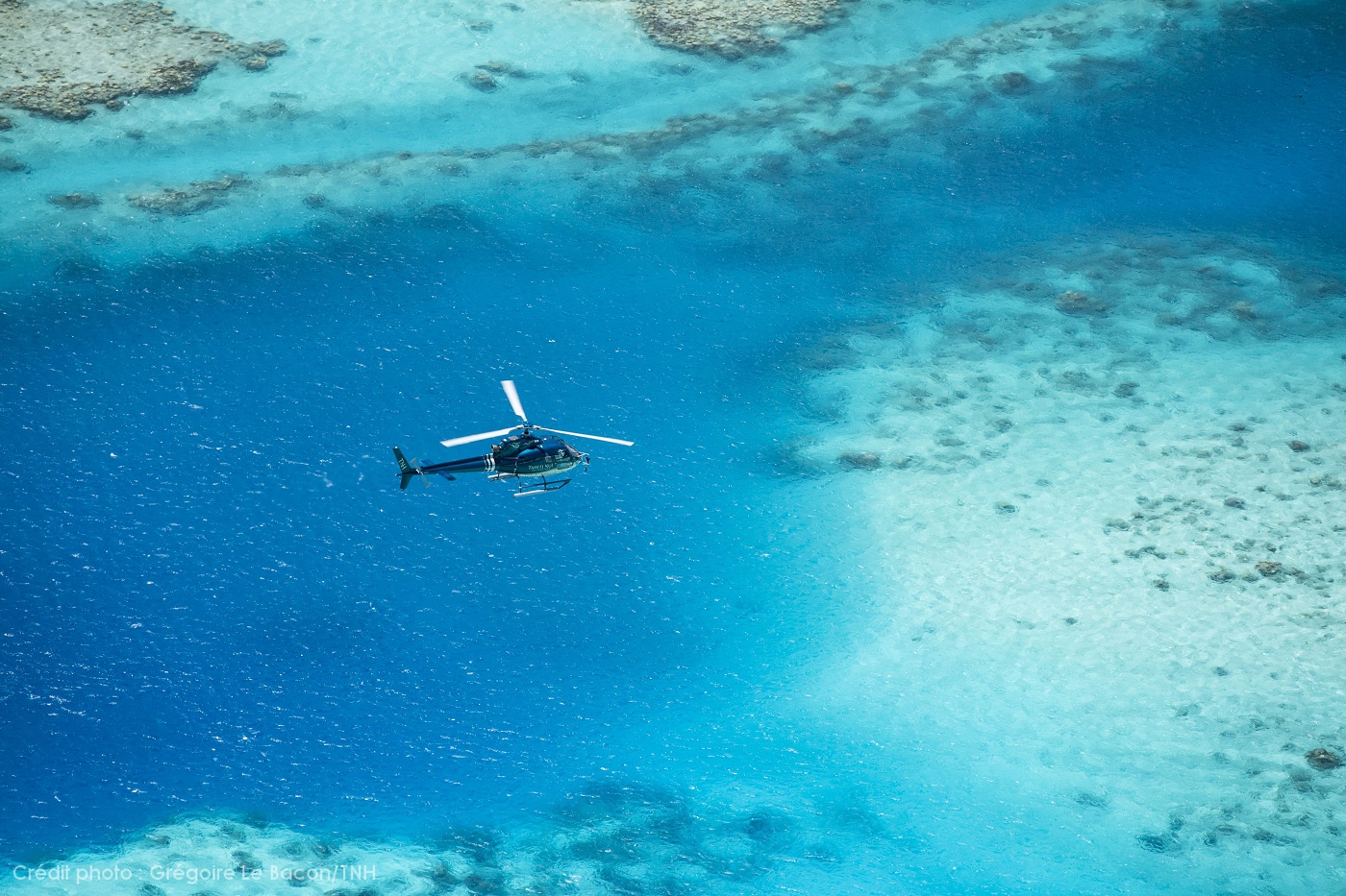 Helicopter flying over lagoon in Moorea