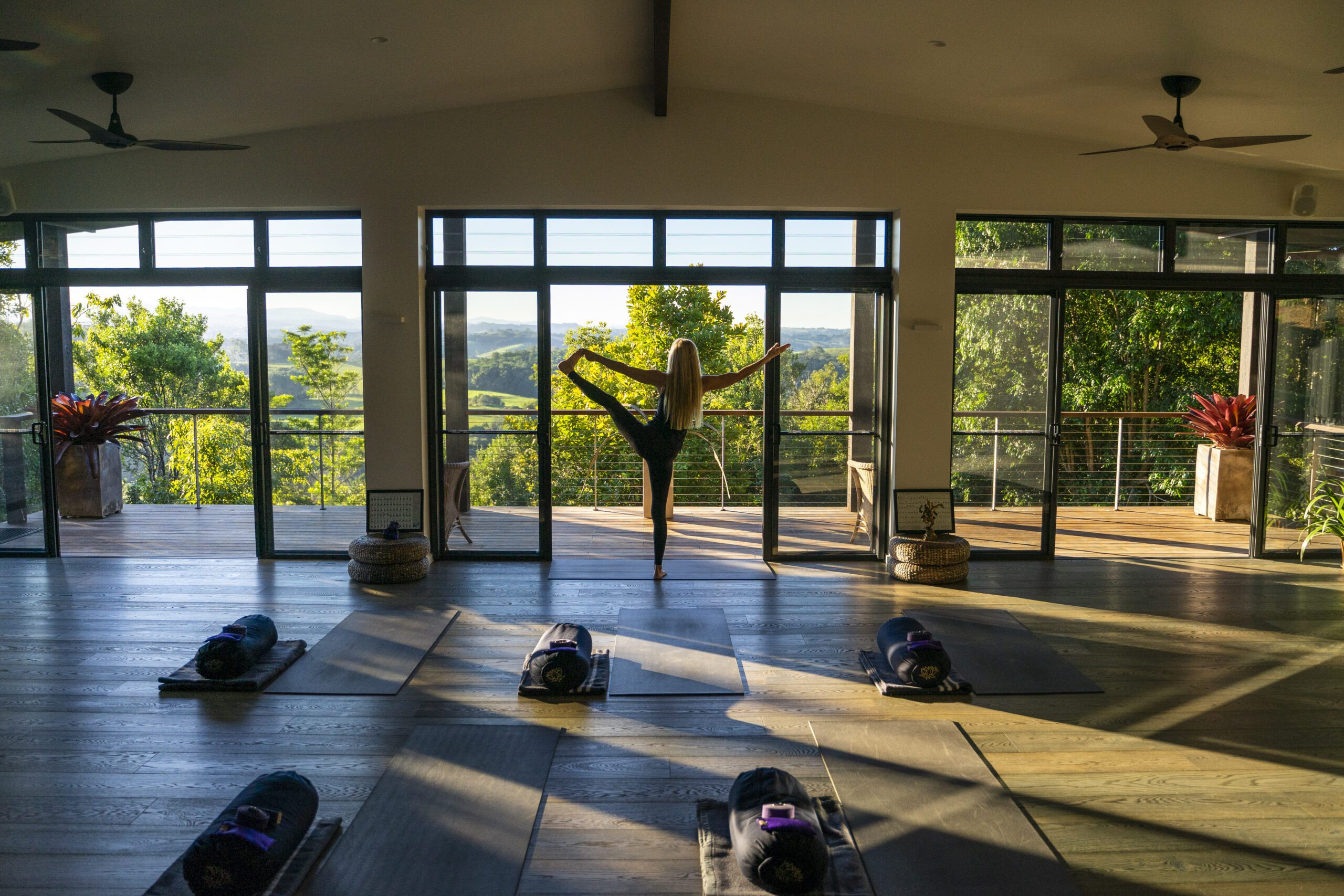 Lady stretching in yoga room at Gaia Retreat