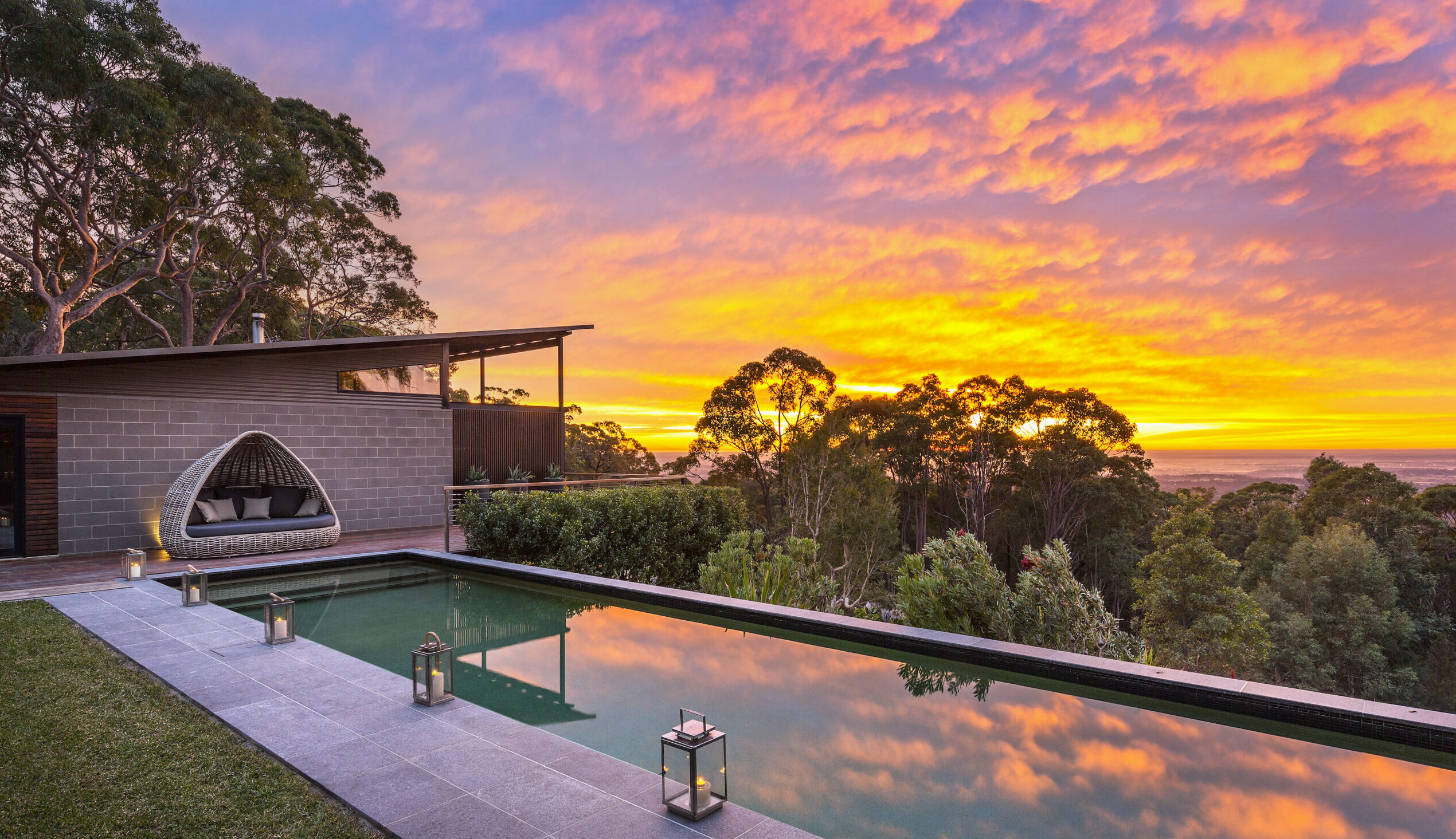 Reflection in pool of sun setting at Spicers Sangoma