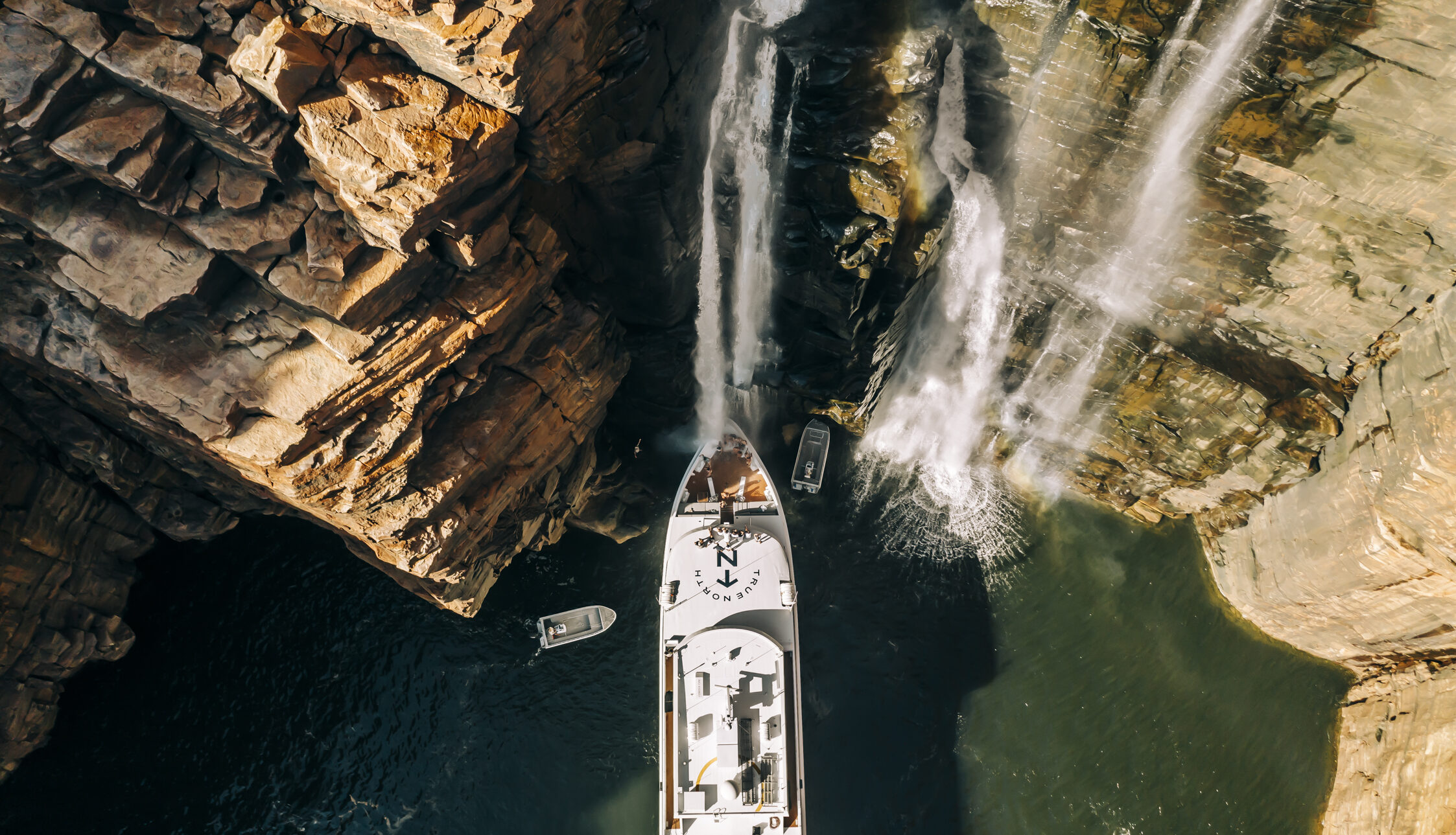 True North cruise ship under waterfalls