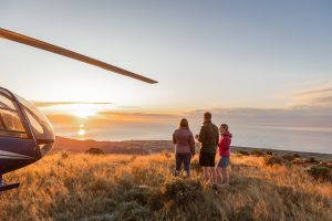Luxury travellers enjoying a glass of champagne with sunrise heli tour on New Zealand's Kaikoura Coast